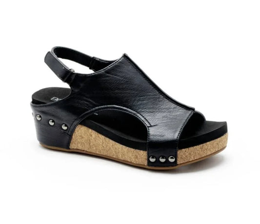 Black wedge sandal with cork sole on a white background