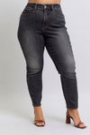 Black jeans worn by a person on a white background