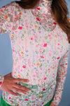 Floral patterned shirt worn by a person with a neutral background