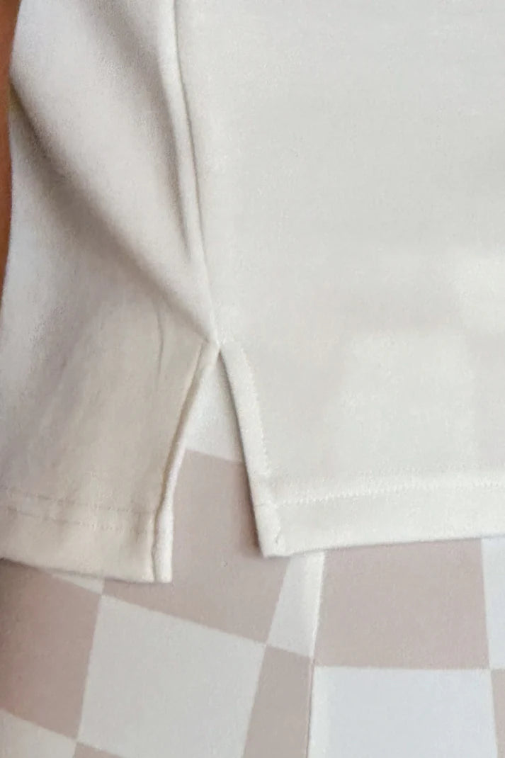 Close-up of a beige fabric with a checkered pattern in the background
