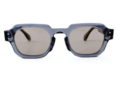 Sunglasses with a clear frame and dark lenses on a white background