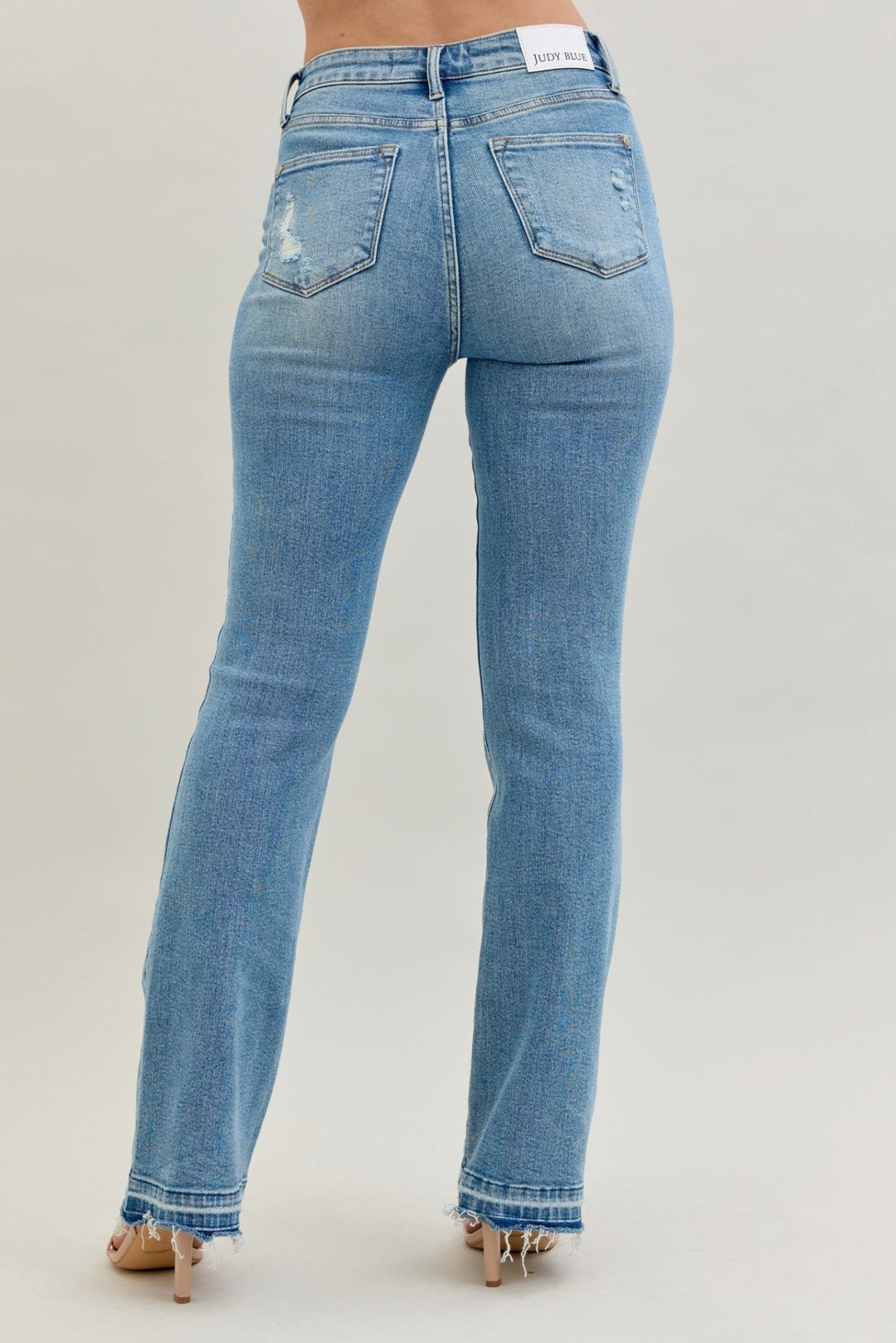 Judy Blue Jeans (NP) - Mid Rise Distressed Release Hem Boot Cut | Nikki &amp; Co. Boutique