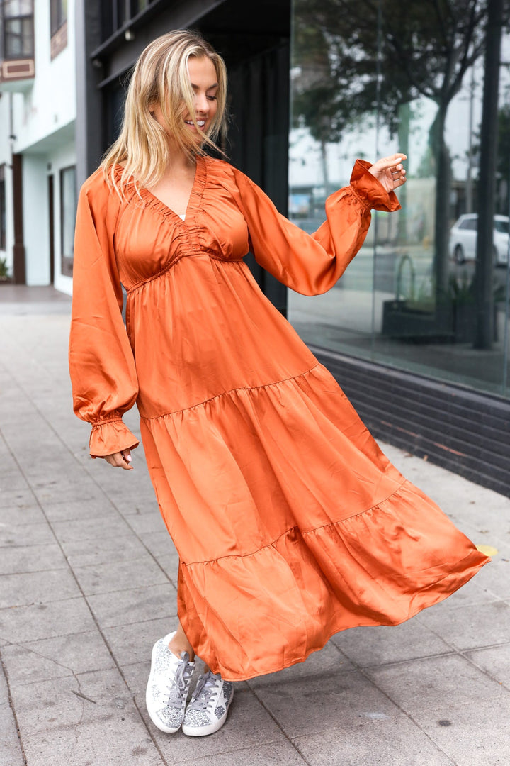 Elegant Rust Elastic V Neck Tiered Satin Maxi Dress | Nikki &amp; Co. Boutique