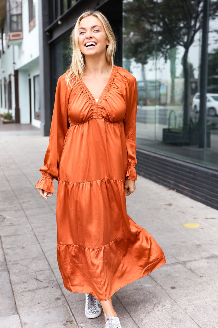 Elegant Rust Elastic V Neck Tiered Satin Maxi Dress | Nikki &amp; Co. Boutique