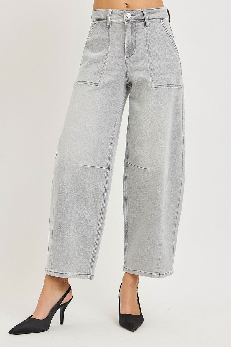 Light gray wide-leg jeans worn by a person on a plain background
