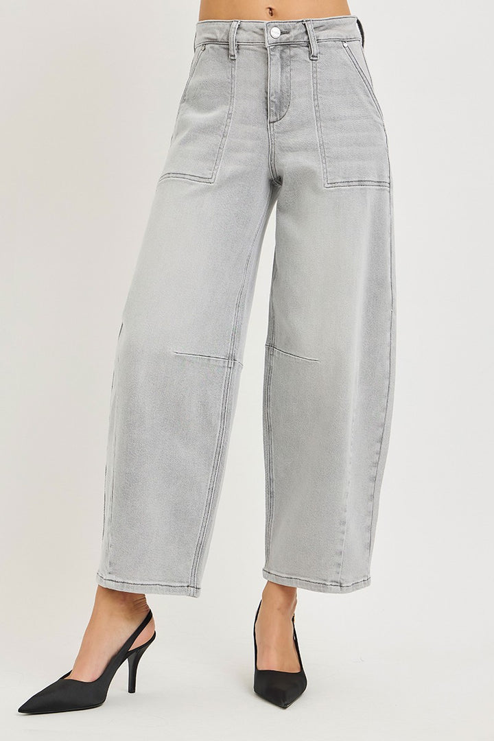 Light gray wide-leg jeans worn by a person on a plain background
