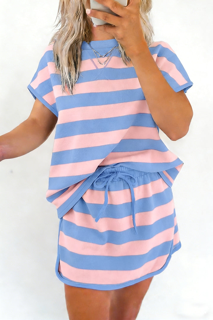 Person wearing a pink and blue striped set on a white background