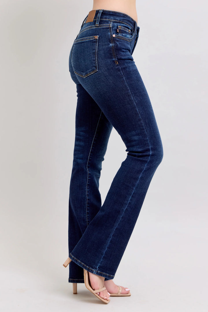 Blue jeans worn by a person on a white background