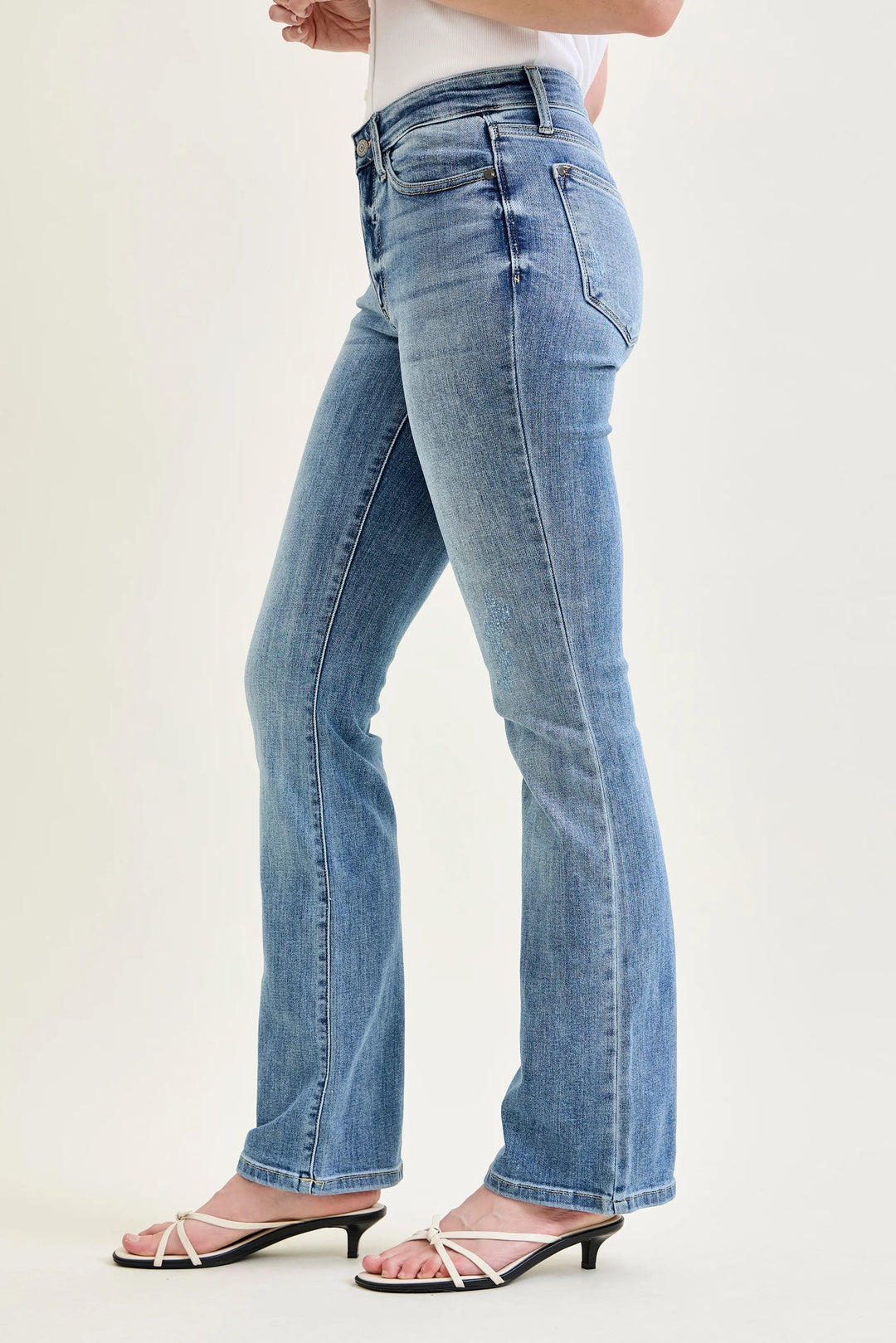 Light blue jeans worn by a person on a white background