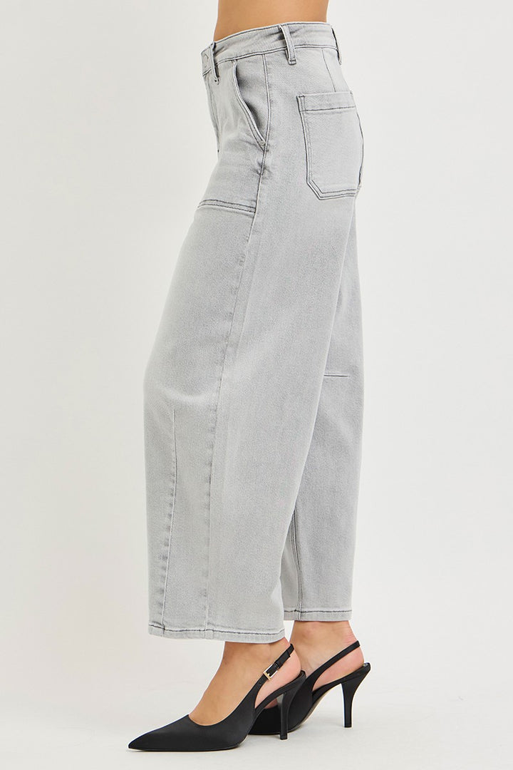 Light gray jeans worn by a person on a white background