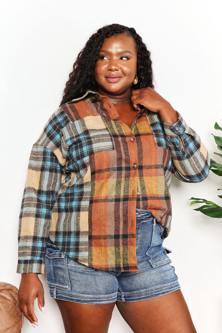 Woman wearing a plaid shirt and denim shorts against a white background