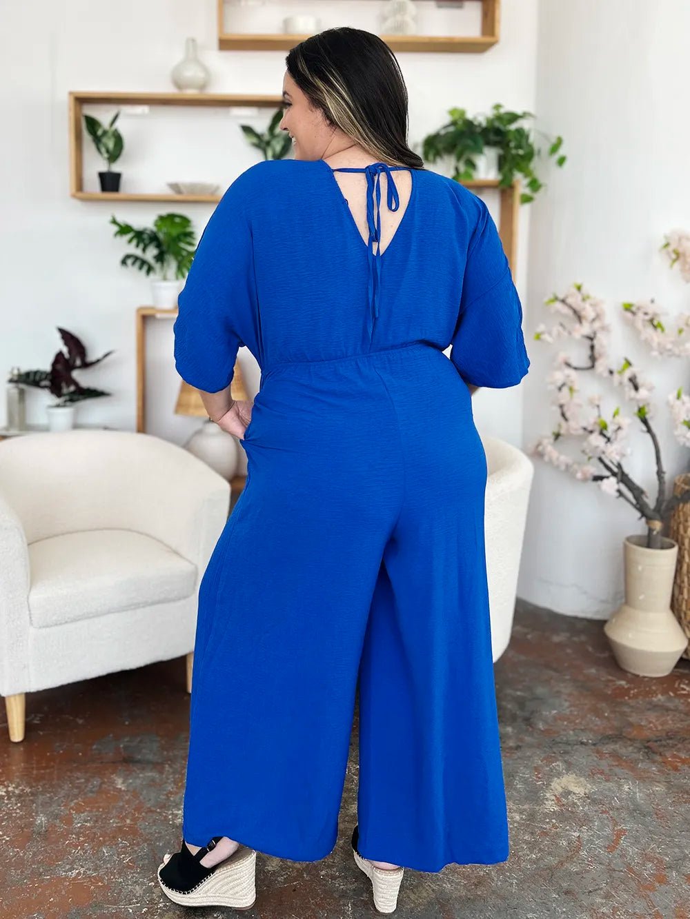 Double Take Full Size Surplice Wide Leg Jumpsuit with Pockets | Nikki &amp; Co. Boutique