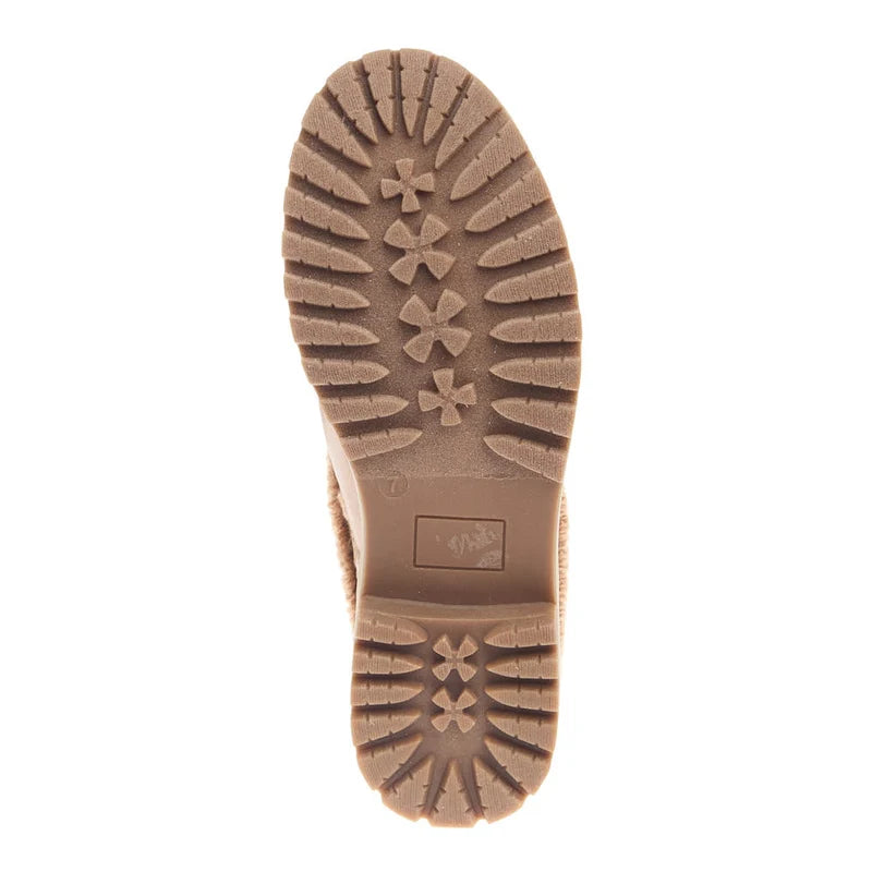 A top-down view of a brown rubber boot sole with deep tread patterns and starburst lugs, shown against a plain white background.