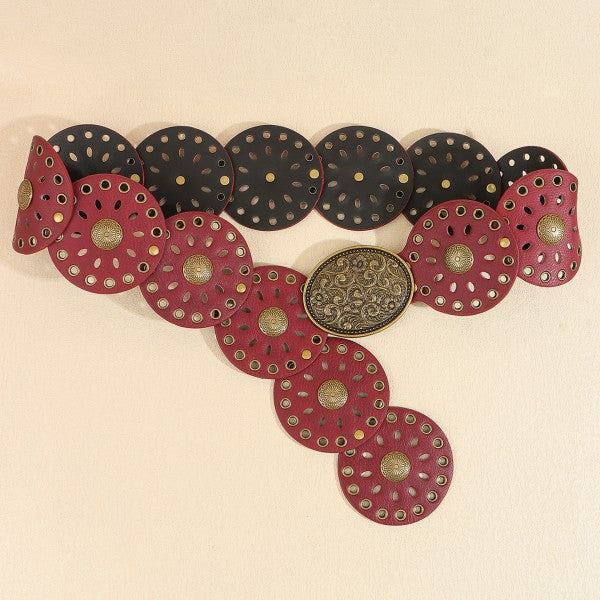 Decorative necklace with red and black circular pendants on a beige background