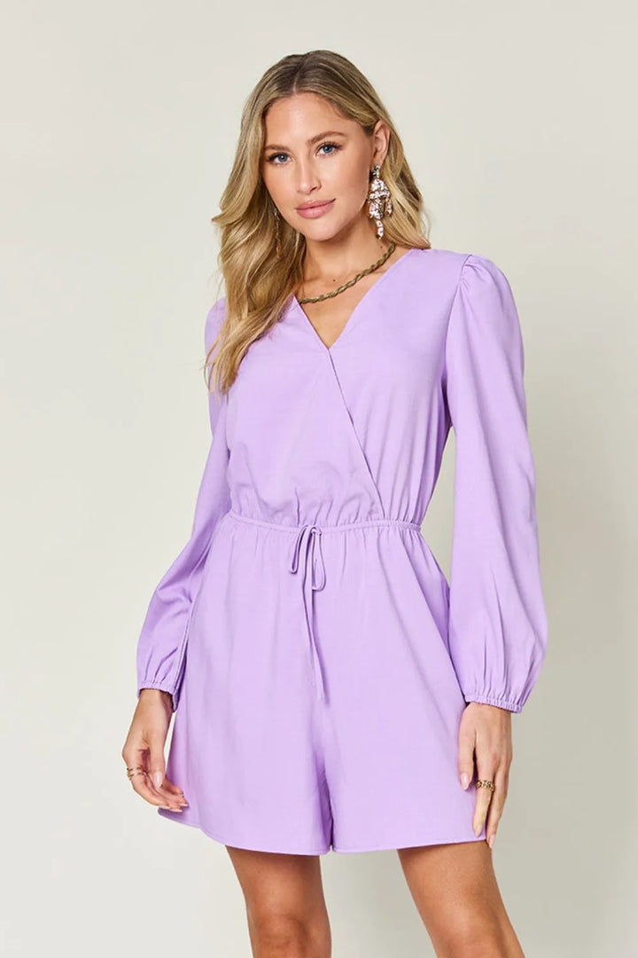Woman wearing a purple dress against a plain background