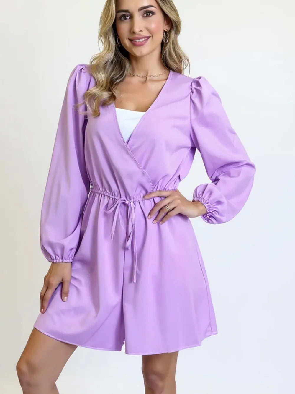 Woman in purple romper with white top underneath 