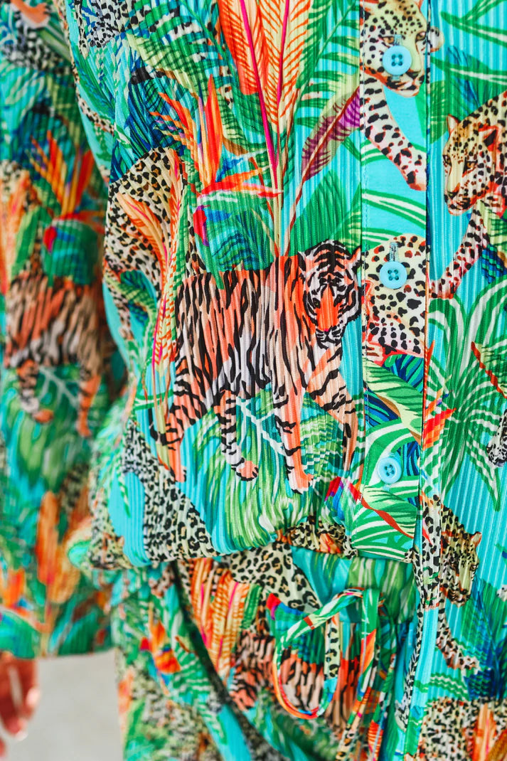 Colorful fabric with a jungle-themed pattern featuring leopards and tigers.