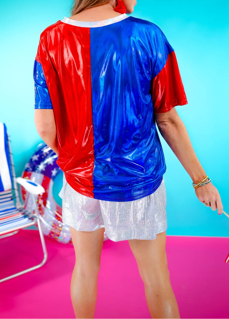 Back side of half red, half blue metallic top.