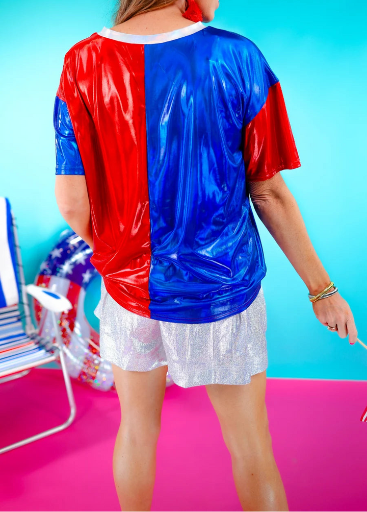 Back side of half red, half blue metallic top.