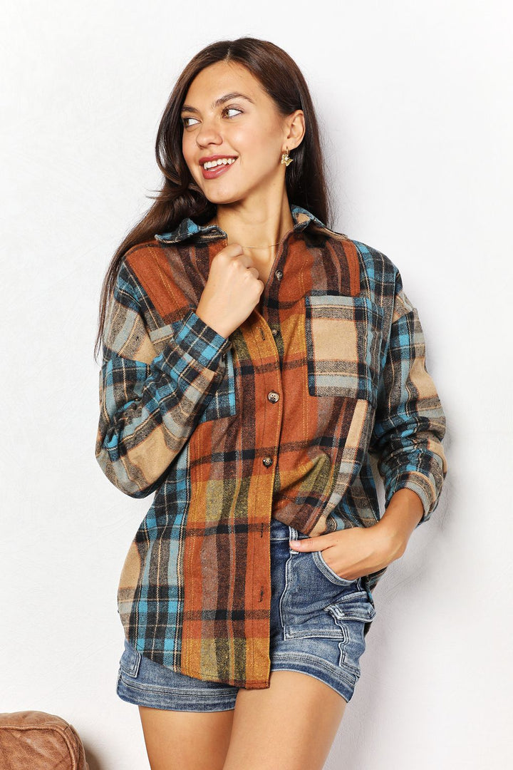 Woman wearing a plaid shirt and denim shorts on a white background