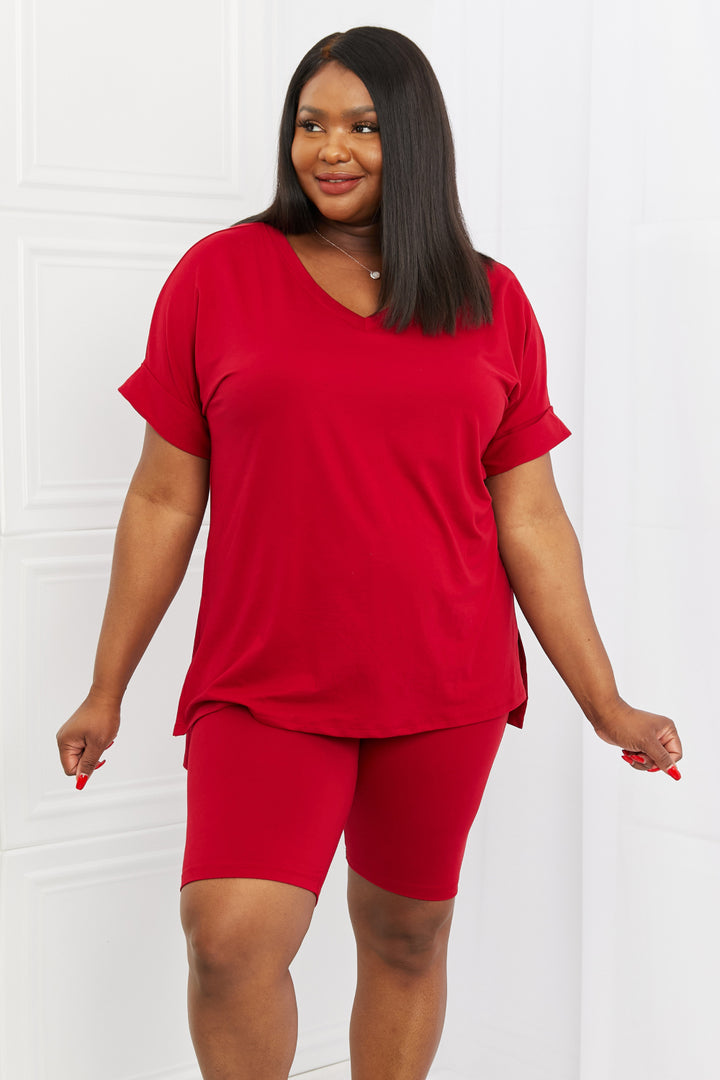 Woman wearing a burgundy outfit against a white background