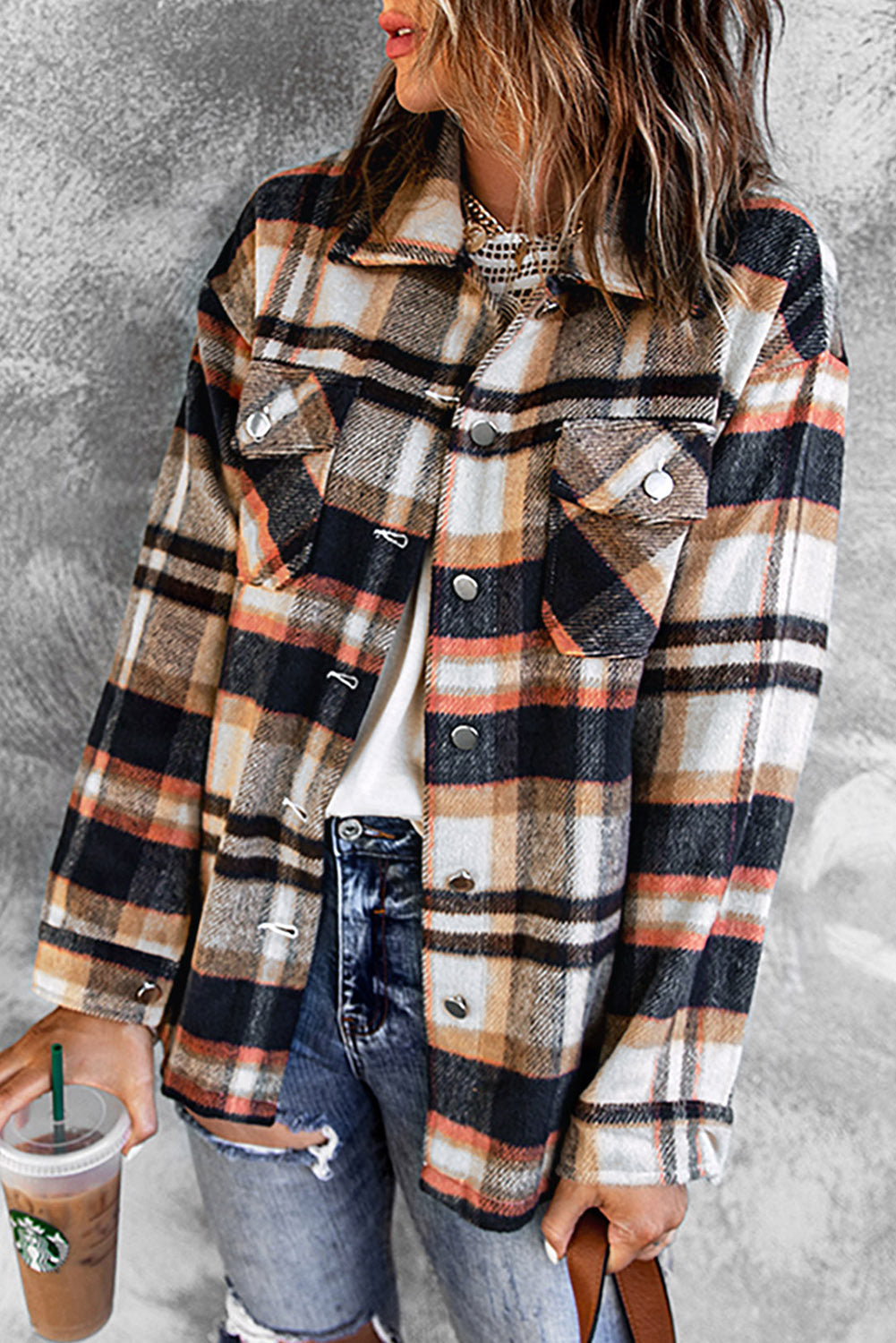 Person wearing a plaid shirt with a gray background