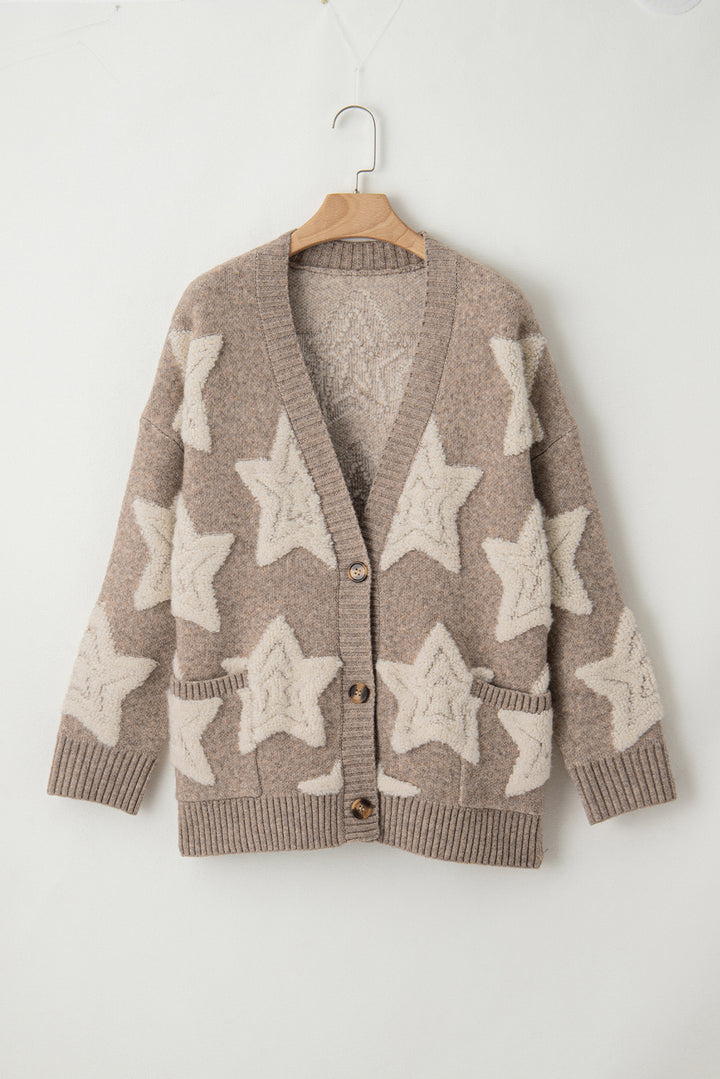 Brown cardigan with star patterns on a wooden hanger against a white background