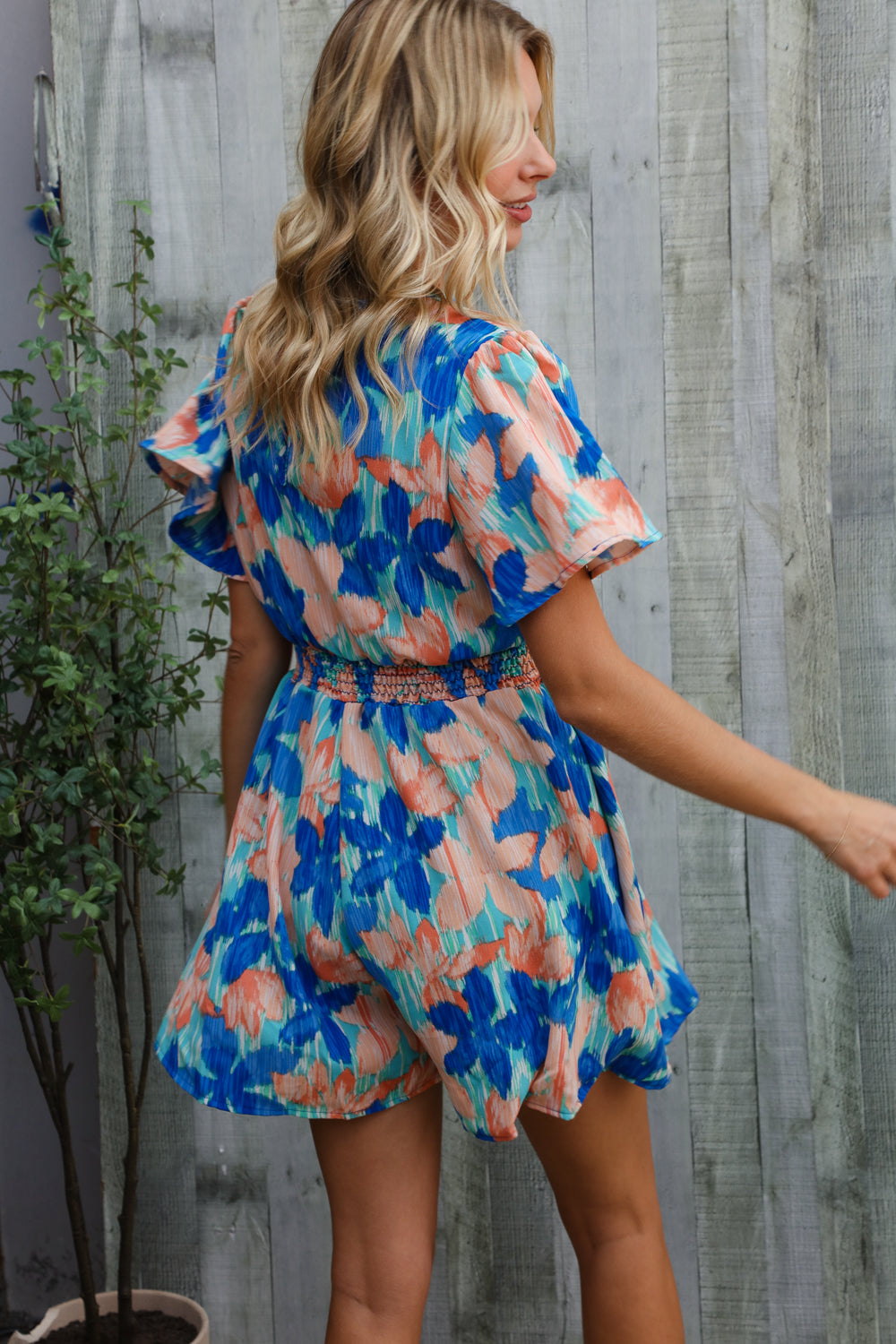 Feeling Bold Turquoise Floral Smocked Waist Flutter Sleeve Romper | Nikki &amp; Co. Boutique