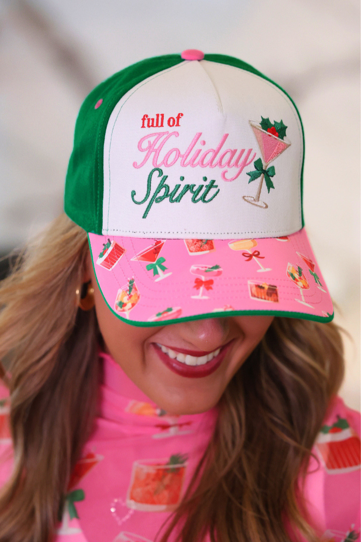 A woman wearing a green and white trucker-style baseball cap with &