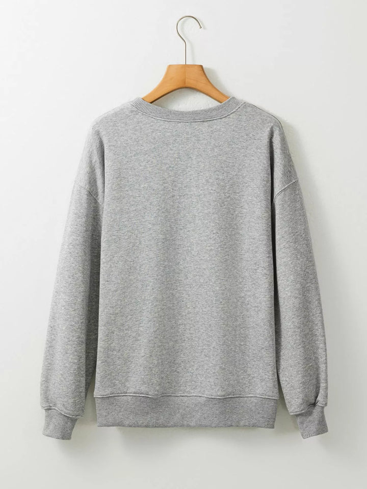 Back of grey sweatshirt hanging from a hanger