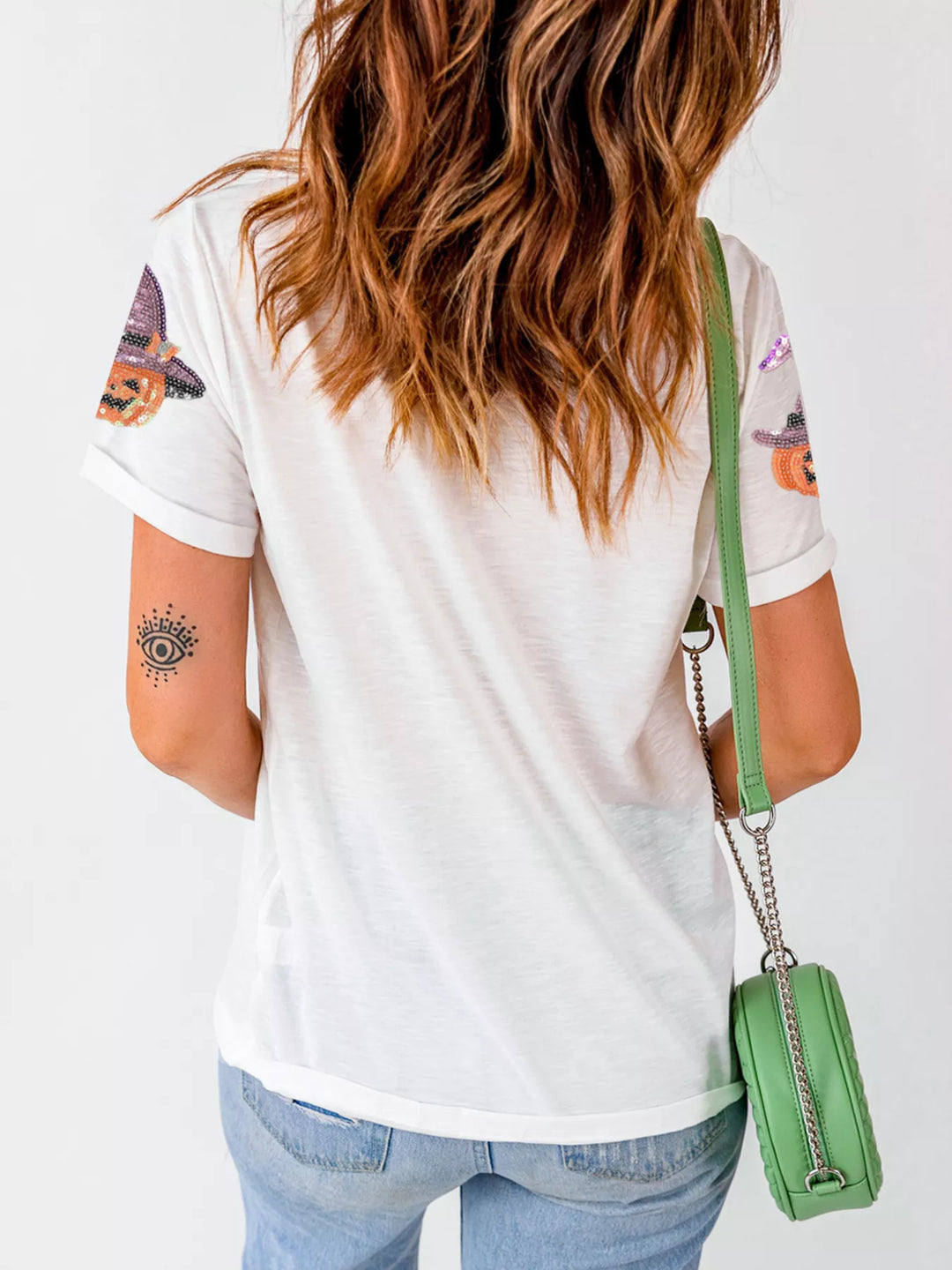 Women wearing top while facing the wall