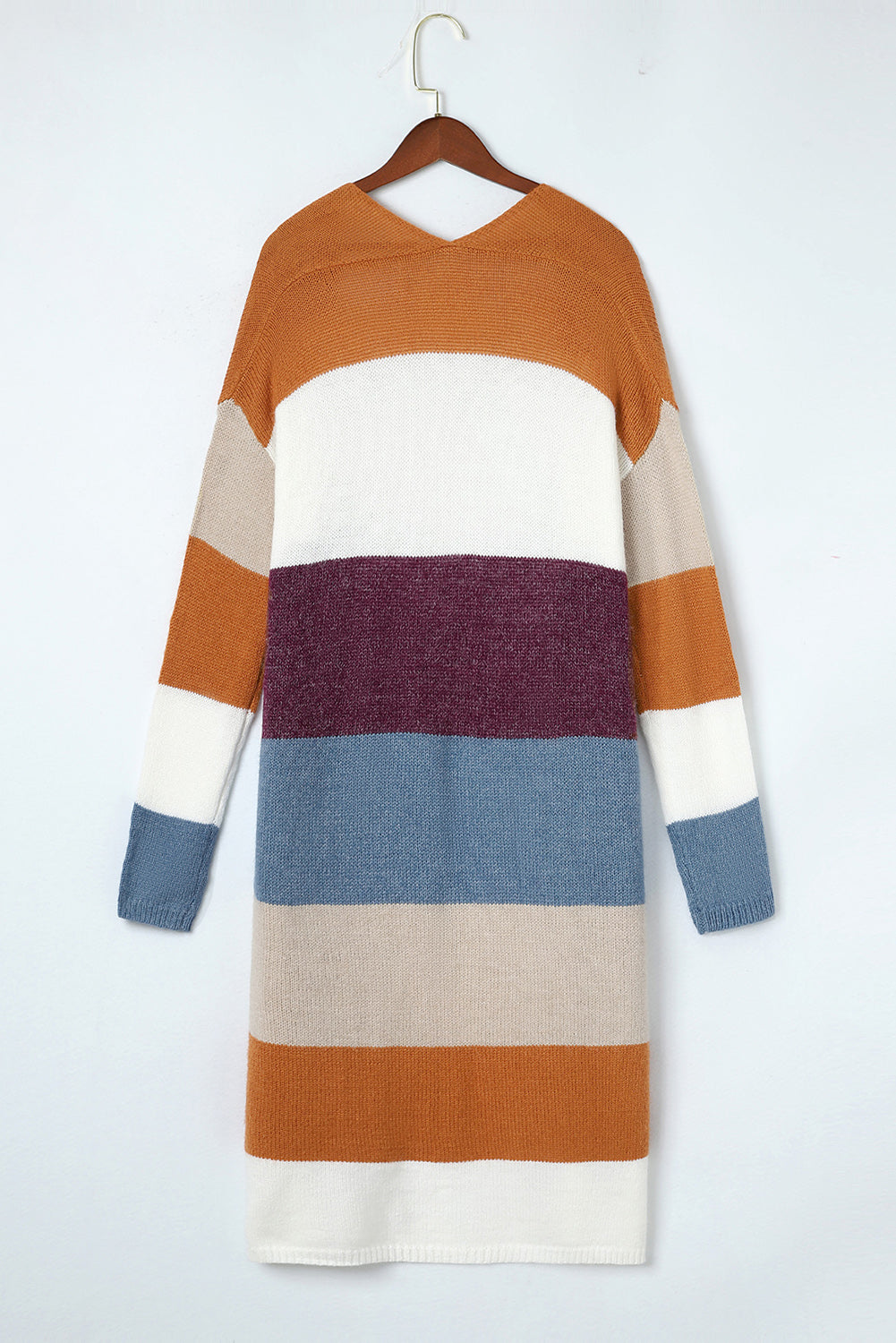 Color-blocked sweater on a hanger against a white background