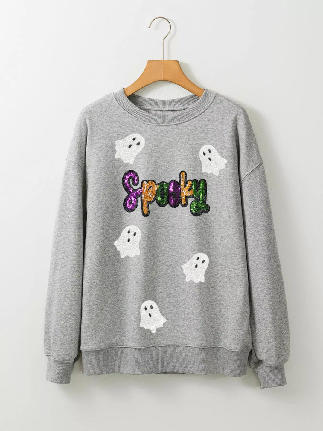 Grey sweatshirt with the word "Spooky" in purple, orange, and green sequence with 5 ghost flying around 