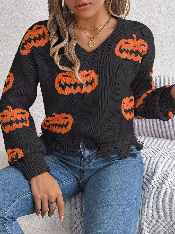 Women wearing black sweater with pumpkins on it while sitting