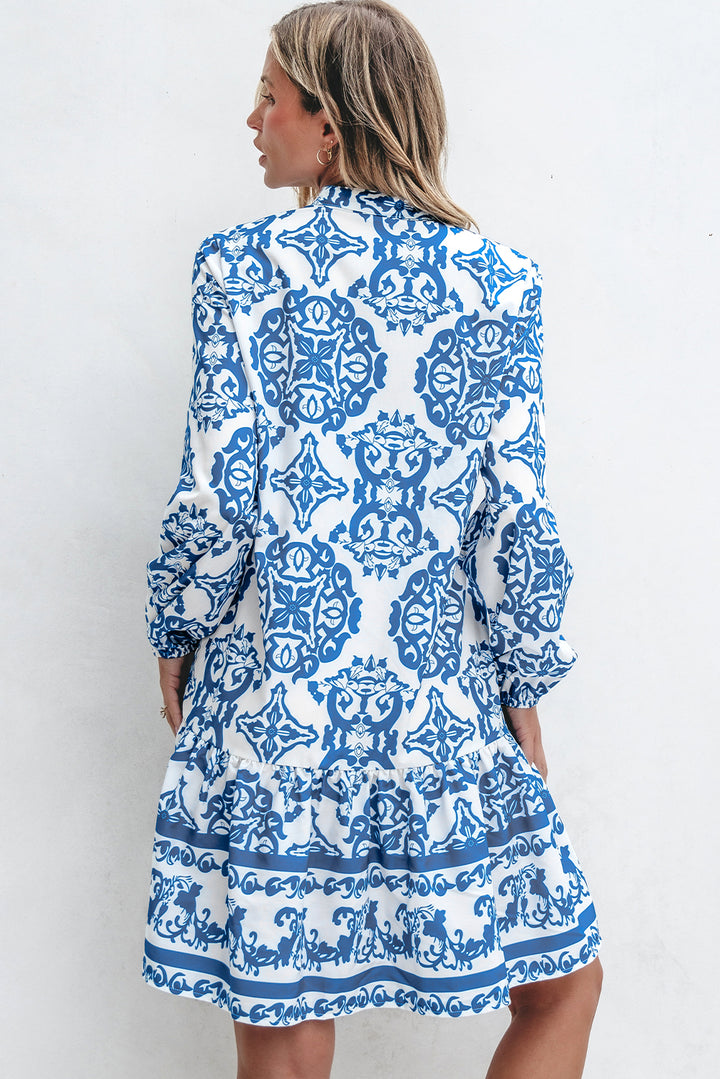 Woman wearing a blue and white patterned dress against a white background