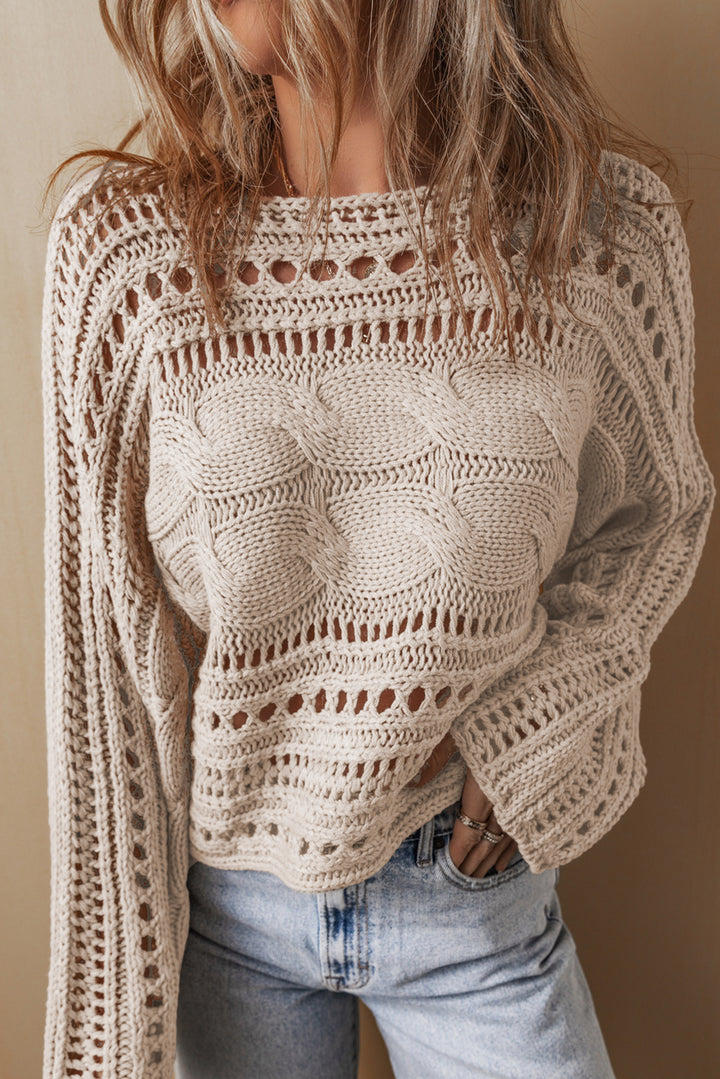 Beige crochet sweater worn by a person against a neutral background