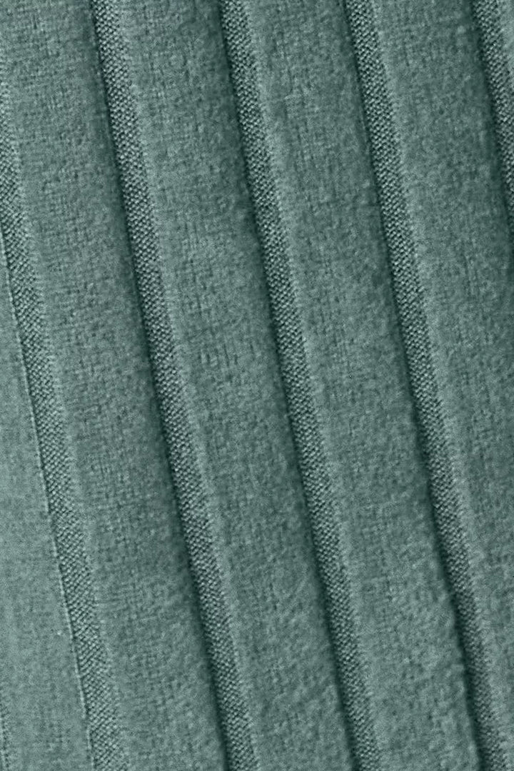 Close-up of pleated fabric with a greenish-brown color.