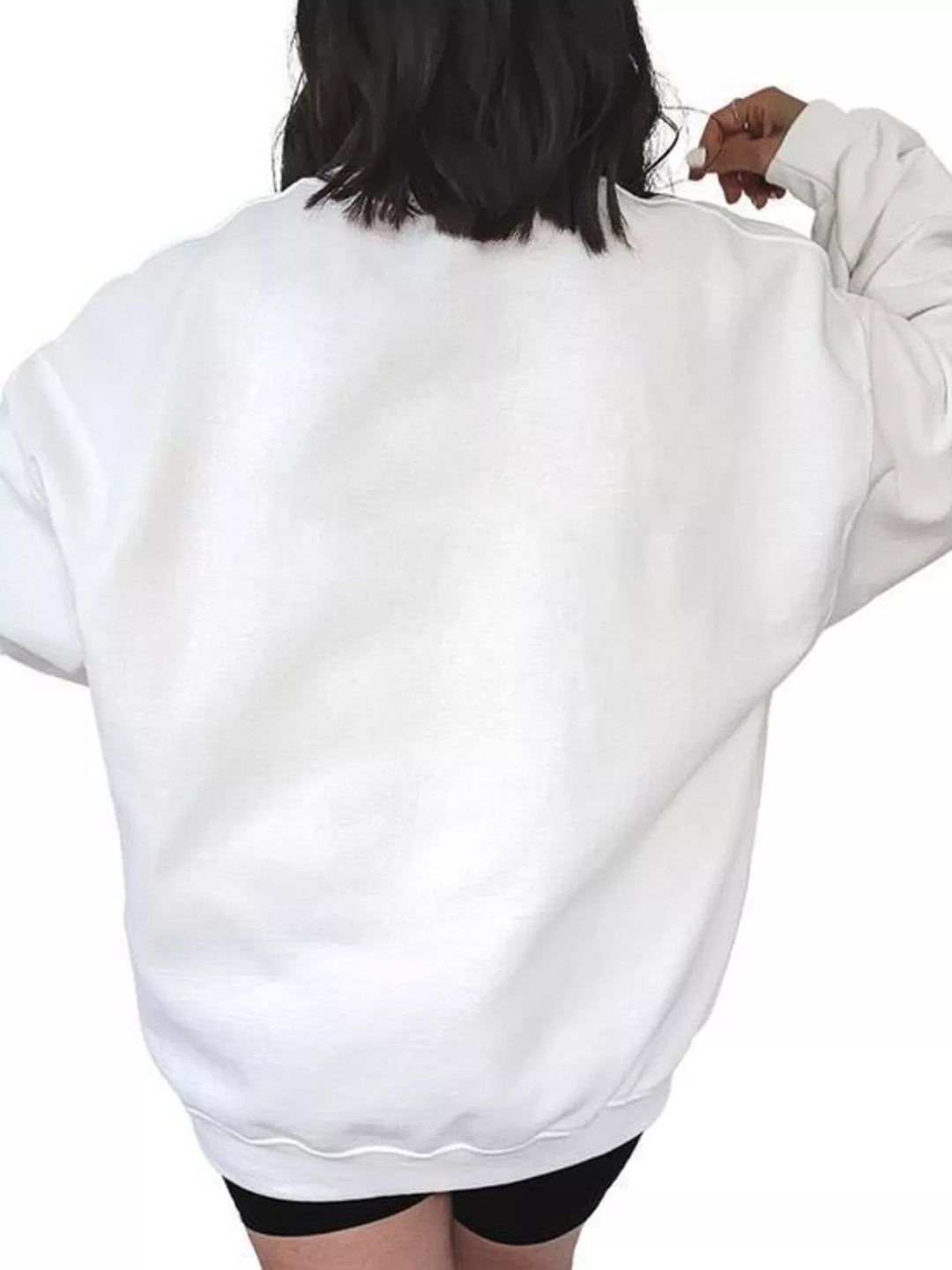 Women wearing white sweatshirt facing the wall