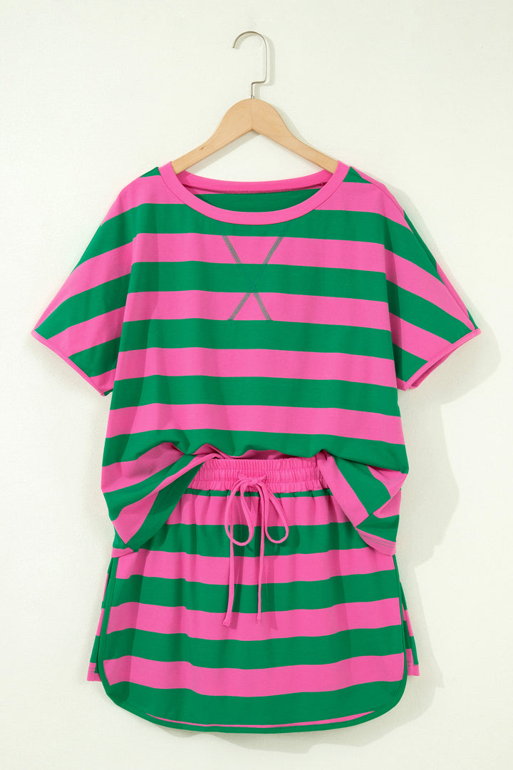 Green and pink striped outfit on a hanger against a white background