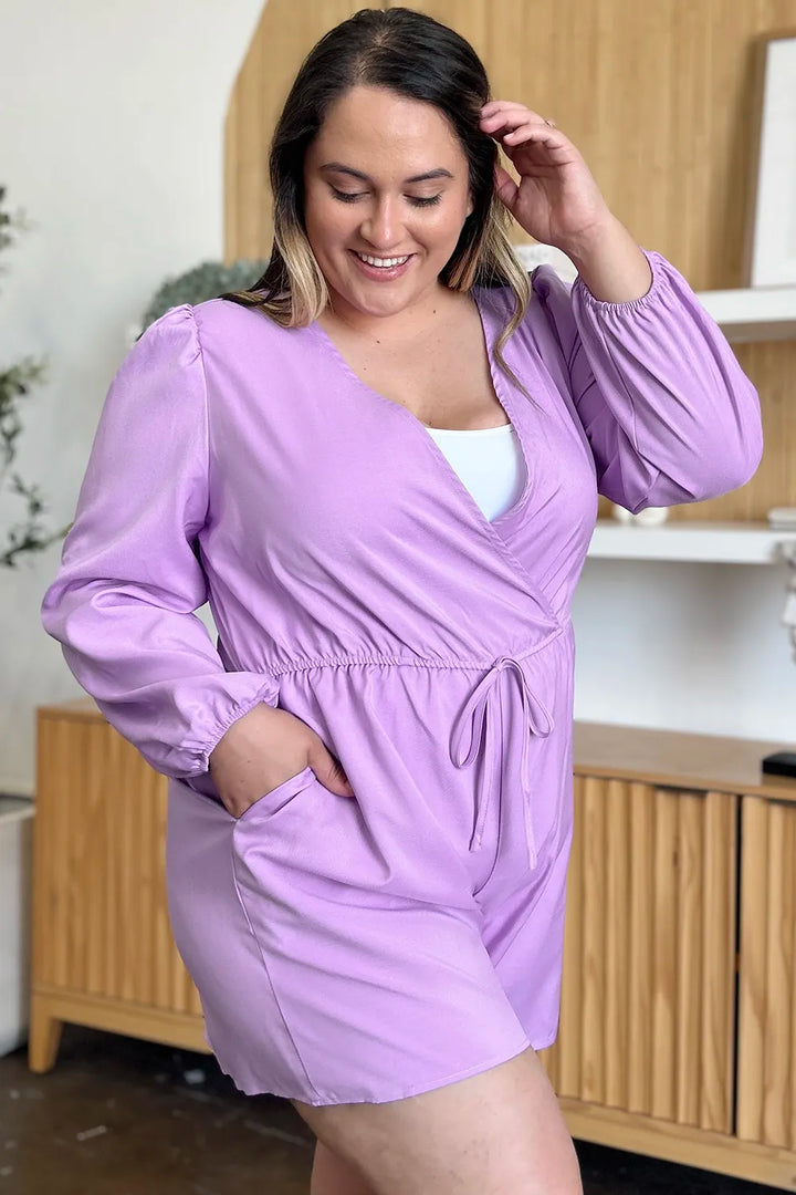 Woman wearing a light purple dress with long sleeves in an indoor setting.