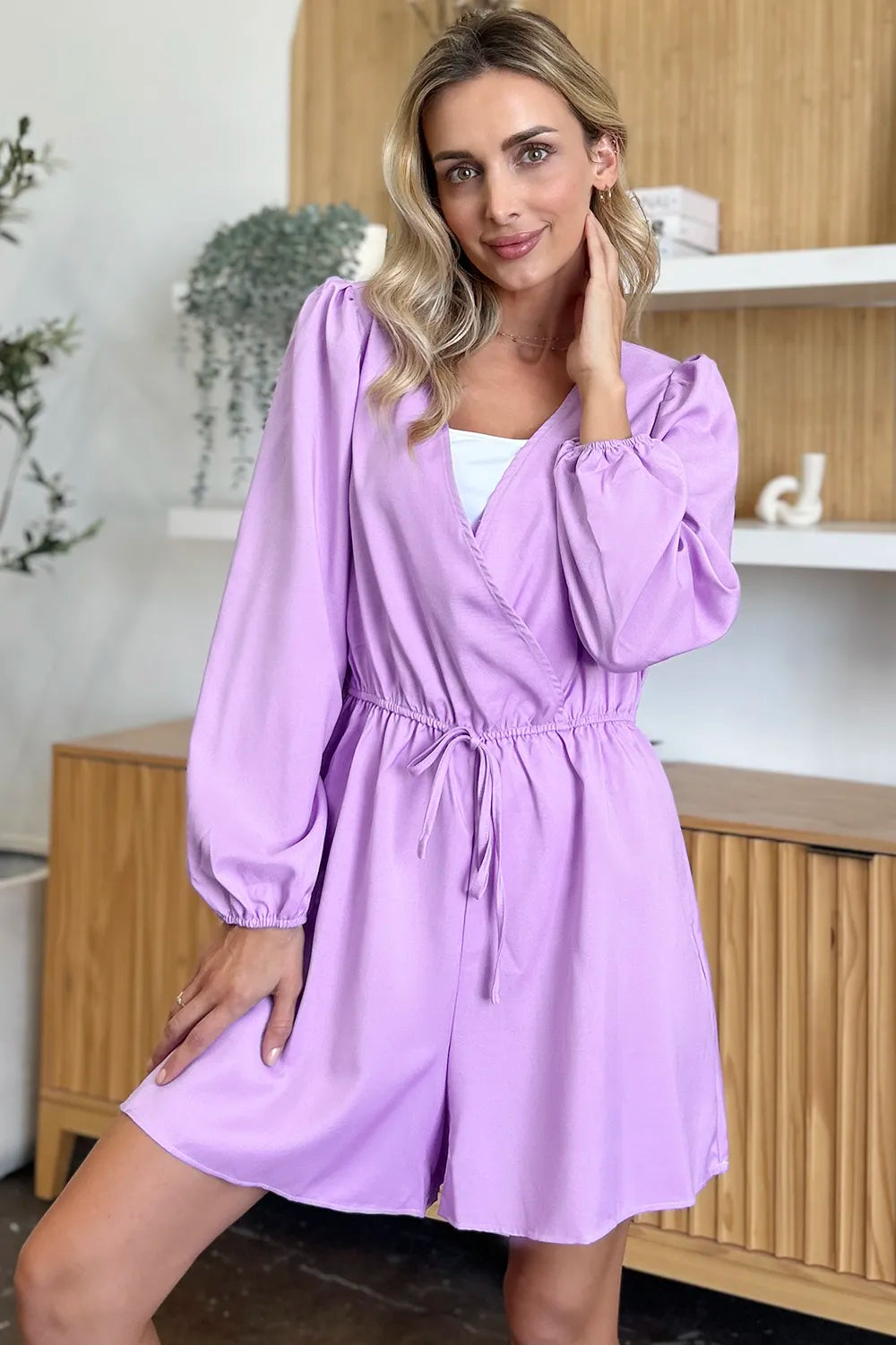 Woman wearing a light purple dress in a kitchen setting
