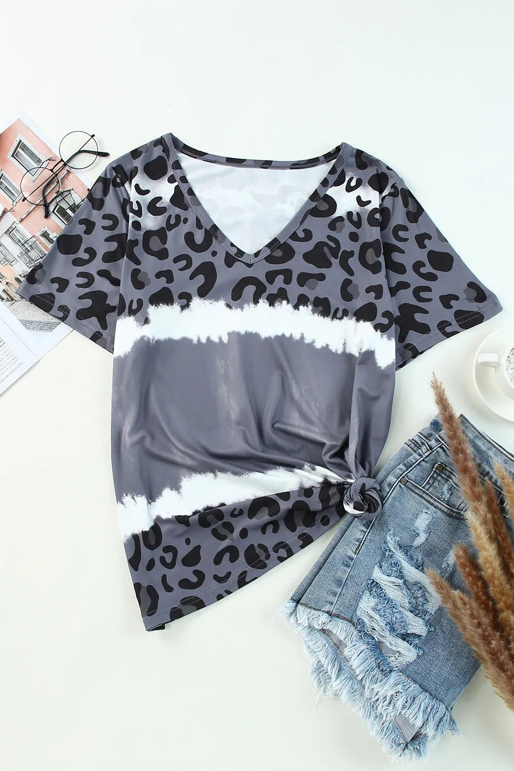 Gray leopard print top with denim shorts on a white surface