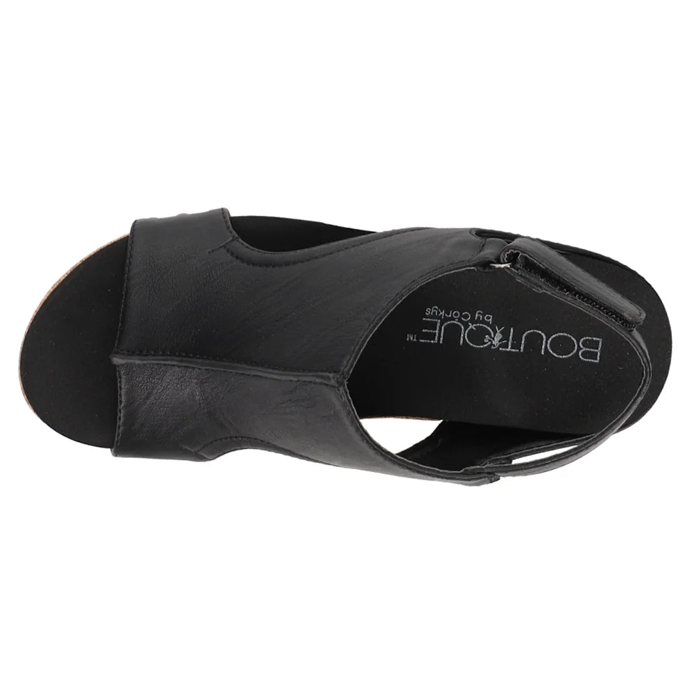 Black sandal with 'Boutique' branding on a white background