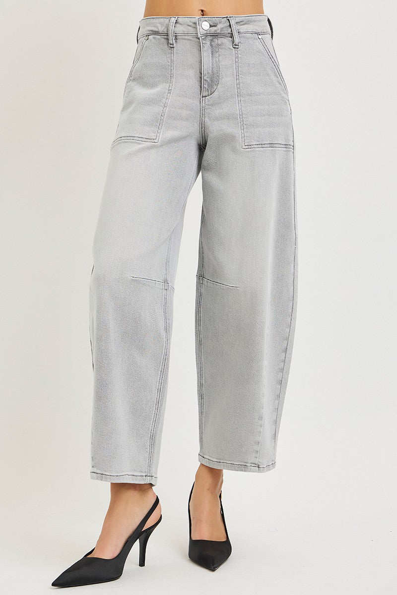 Light gray jeans worn by a person on a plain background