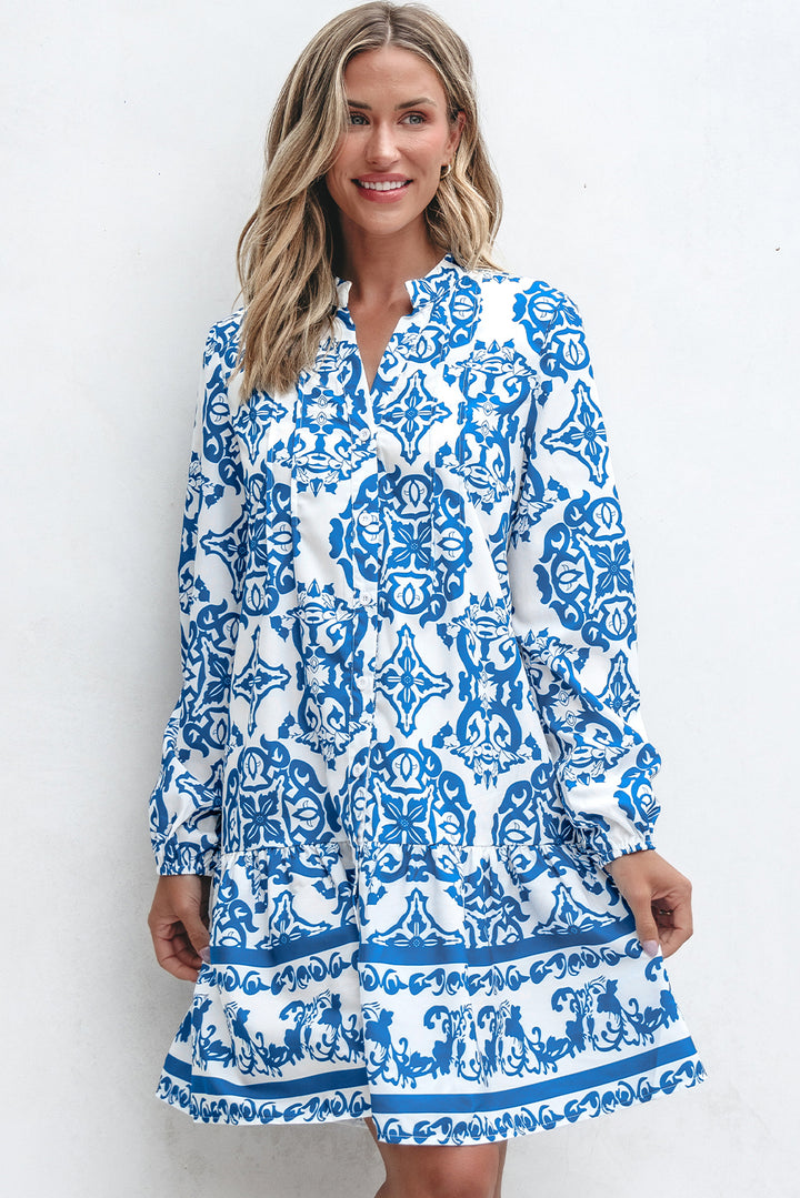 Woman wearing a blue and white patterned dress against a white background
