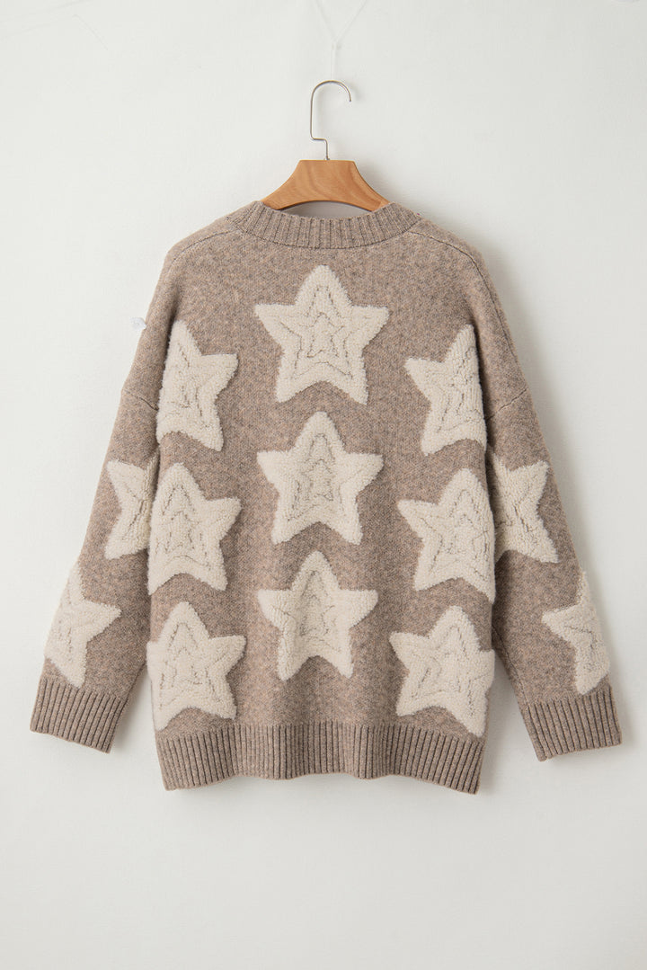 Brown sweater with star patterns on a wooden hanger against a white background