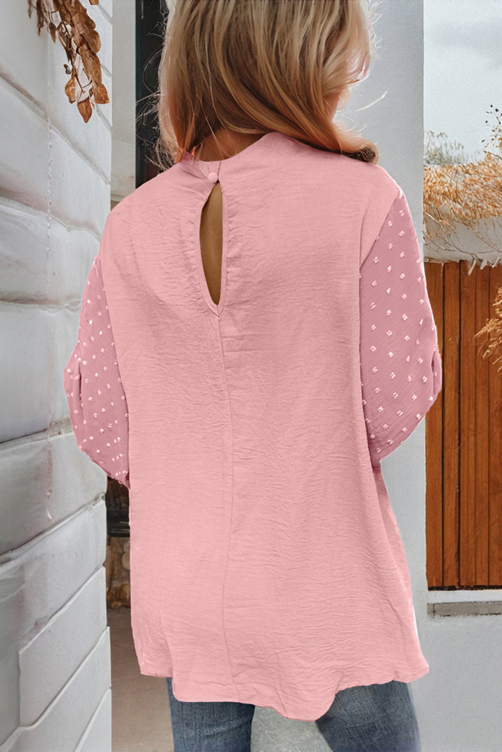 Person wearing a pink blouse with a cut-out back design.
