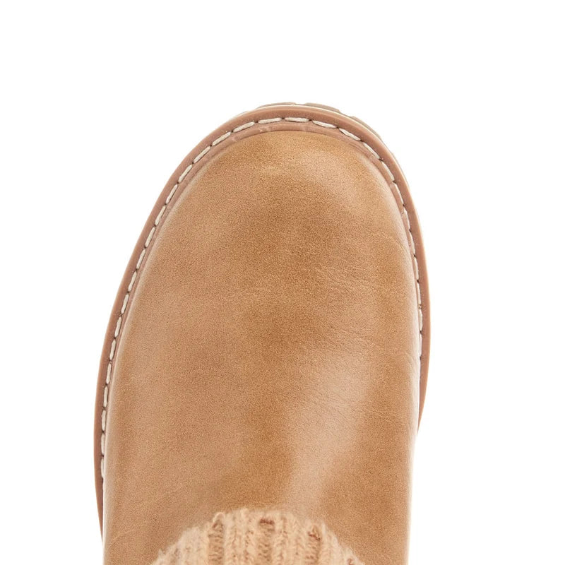 Close-up of a tan boot sole on a white background