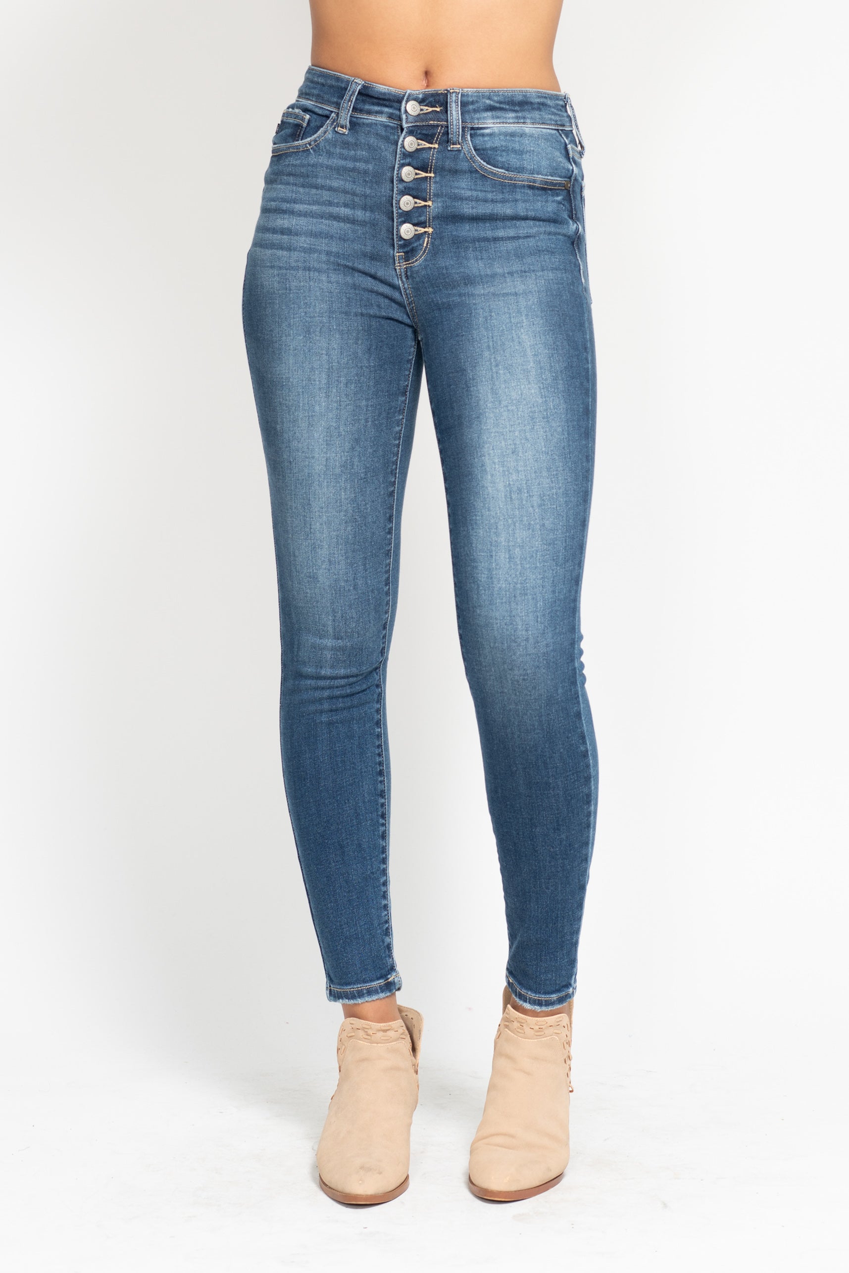 Blue jeans with button details on a white background