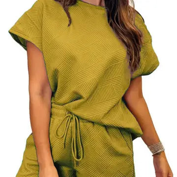 Green textured top and skirt set on a white background
